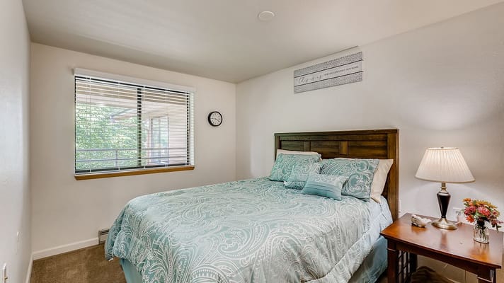 Cozy private bedroom with decorative bedding