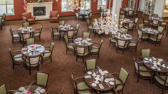 Dining area set for a meal with floral decor