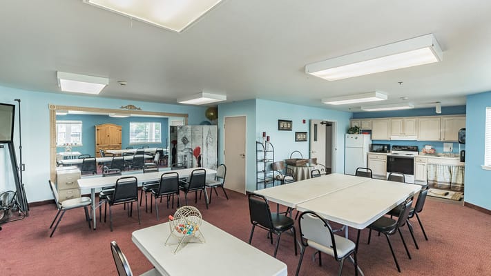 Bright common area with tables and chairs arranged