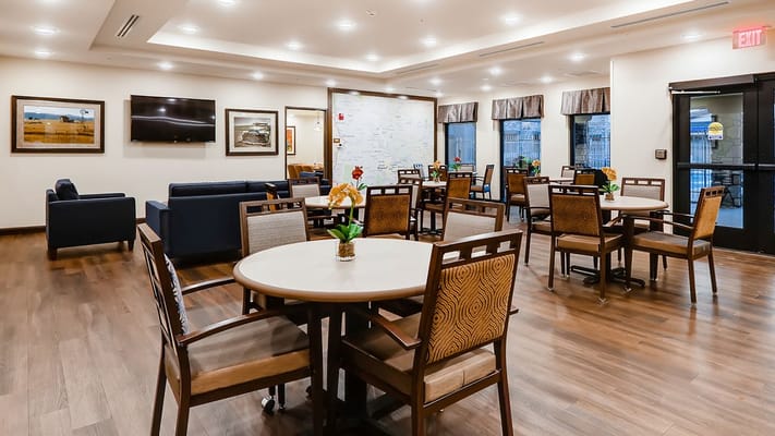 Bright dining area with wooden tables and chairs
