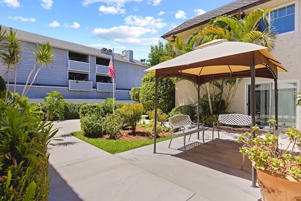 Outdoor seating area with a gazebo and garden