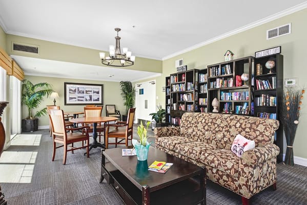 Warm and inviting common area with seating and bookshelves