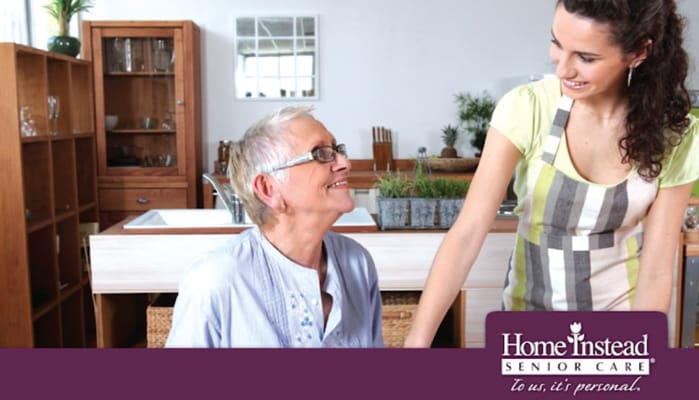 Home Instead Senior Care logo with staff and resident interaction