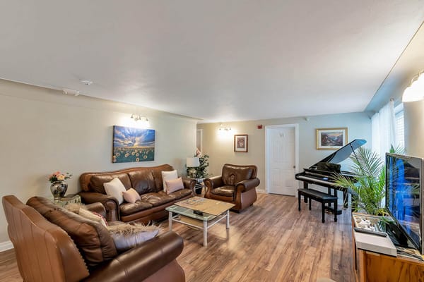 Bright common area with comfortable furniture and piano