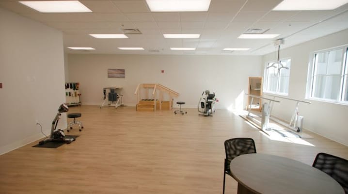 Empty activity room with exercise equipment and natural light