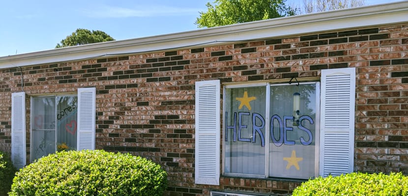 Decorative window signs proclaiming 'Heroes' at a facility