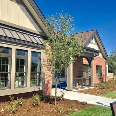 Exterior view of a senior living facility with landscaping