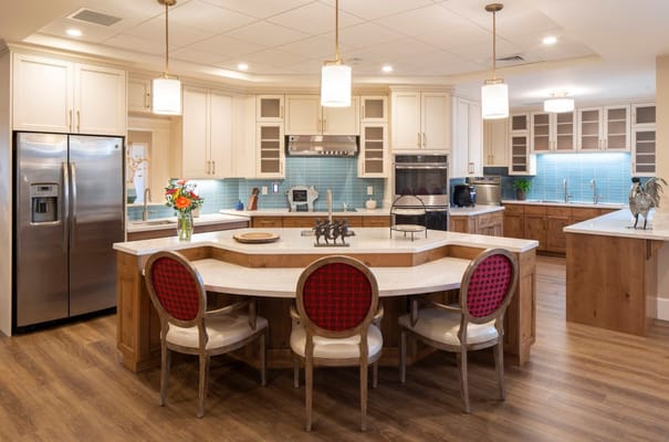 Bright kitchen area with seating and modern appliances