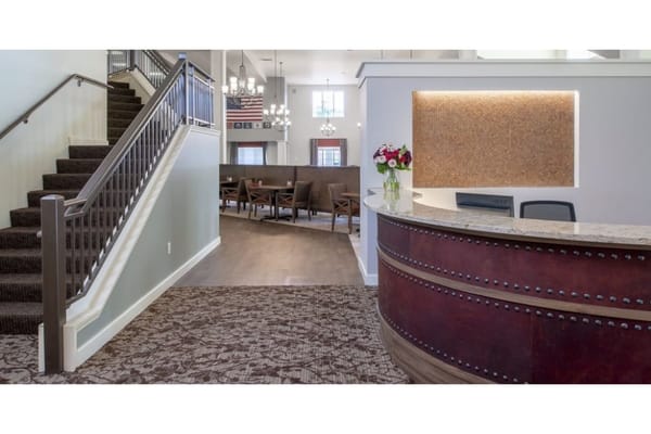 Reception desk with a staircase in the background at Kipling Meadows