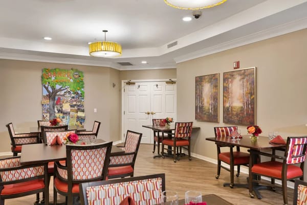 Bright dining area with tables and artwork
