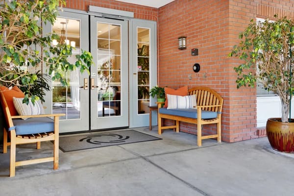 Entrance to a welcoming assisted living facility with seating