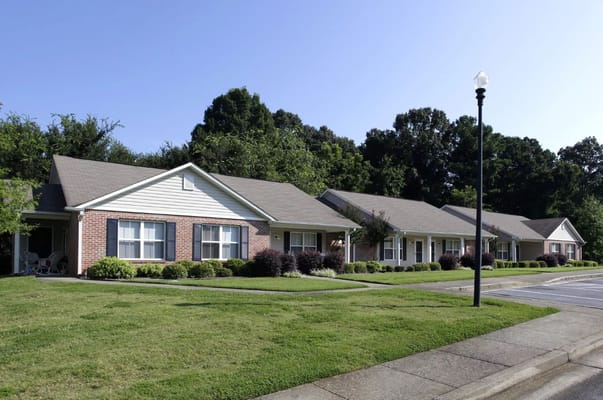 Exterior view of Kirkwood Trails Senior Apartments with landscaped lawns.