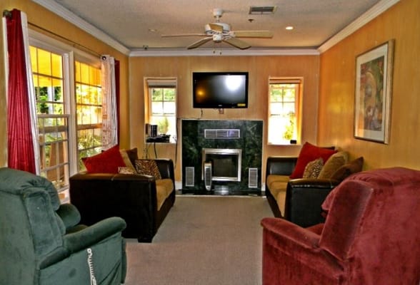 Bright common area with seating and a fireplace