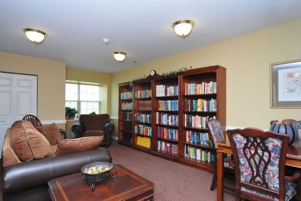 Common area with a comfortable seating arrangement and bookshelves