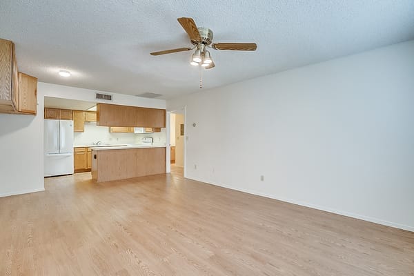 Spacious living area with a kitchen view
