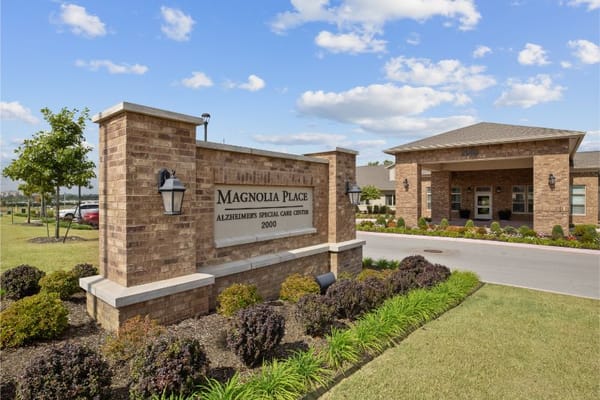 Exterior view of Magnolia Place Assisted Living sign and building