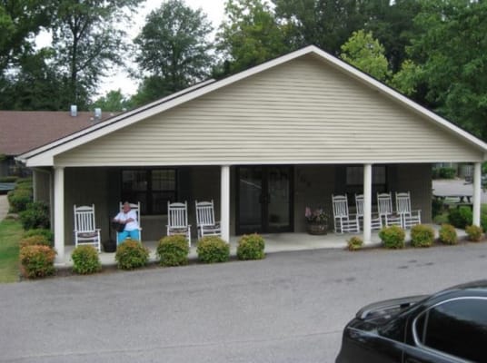 Front view of Maple Ridge Manor featuring rocking chairs