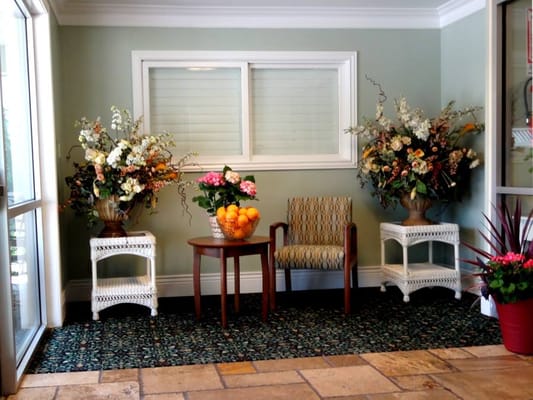 Bright and inviting common area with floral arrangements