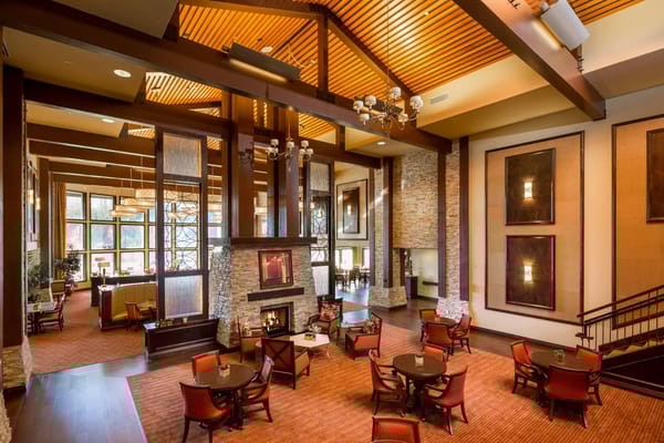 Interior view of a common area with seating and a fireplace