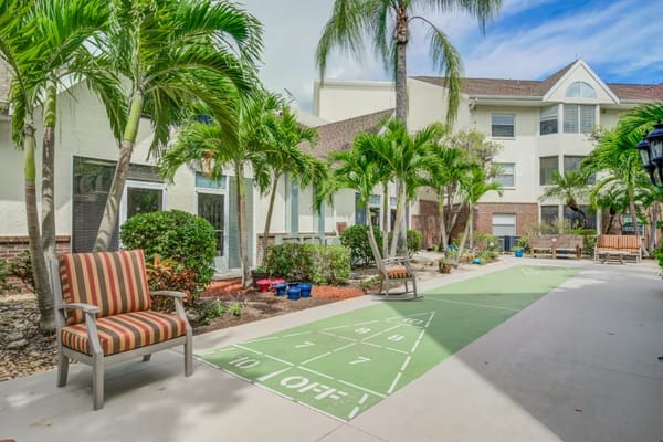 Outdoor courtyard with shuffleboard and palm trees