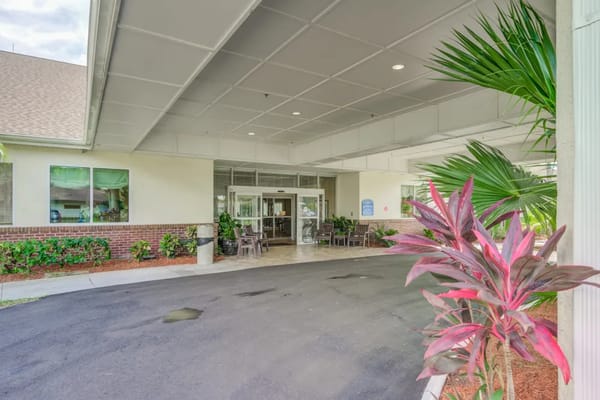 Entrance of the senior living facility with outdoor plants