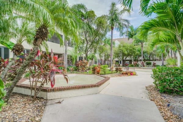 Lush outdoor garden walkway with fountain