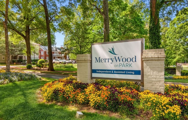 Welcome sign at Merrywood on Park with colorful flowers
