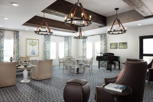 Bright common area with piano and seating