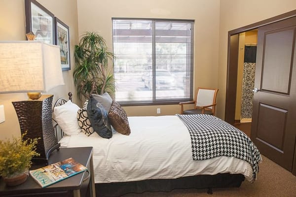 Cozy private resident room with a bed and plant