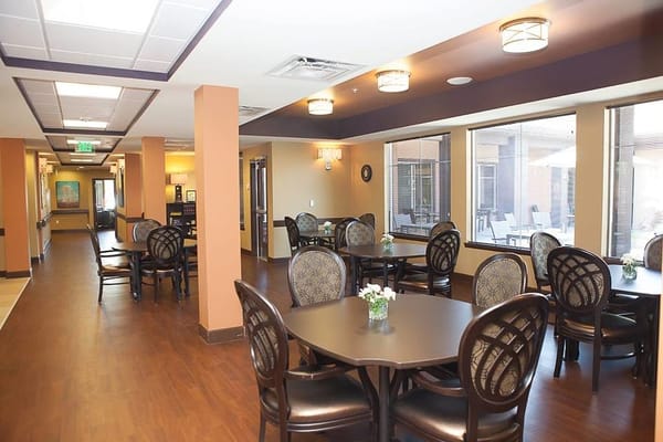 Interior dining area with round tables and flowers