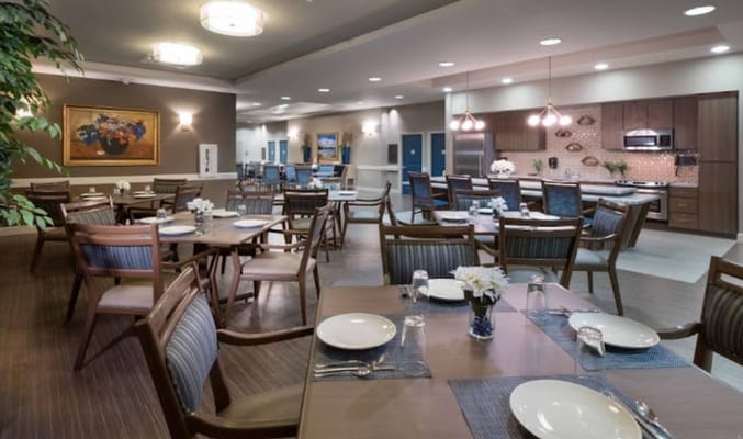 Dining area with tables and chairs set for meals
