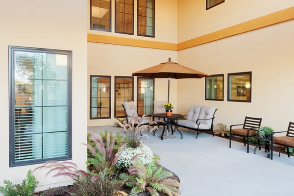 Outdoor lounge area with seating and umbrella