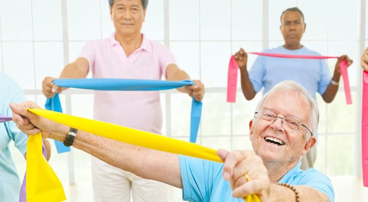 Seniors participating in a group exercise session with resistance bands