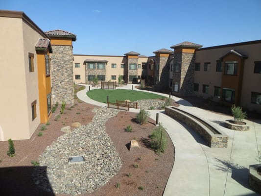 View of the courtyard with landscaped paths and seating areas.