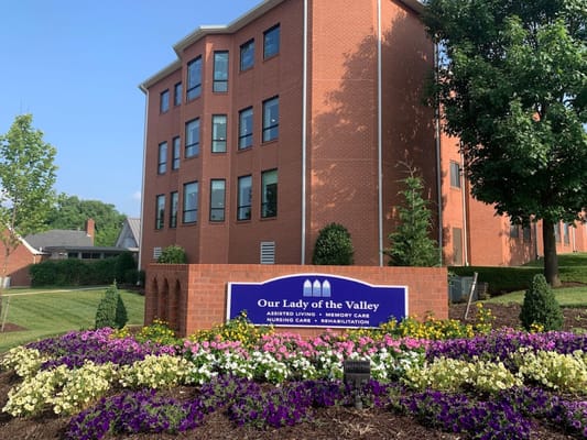 Exterior view of Our Lady of the Valley with flowers