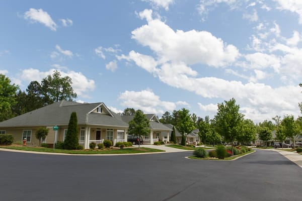 View of residential buildings with trees on a sunny day.