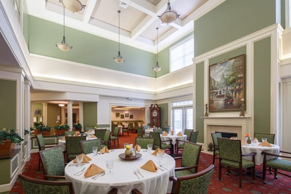 Bright dining room with tables set for meals at Park Pointe Village