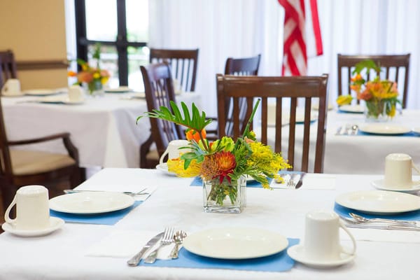 Dining room setup with flowers and tableware