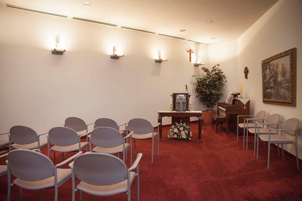 A serene chapel with chairs and religious icons