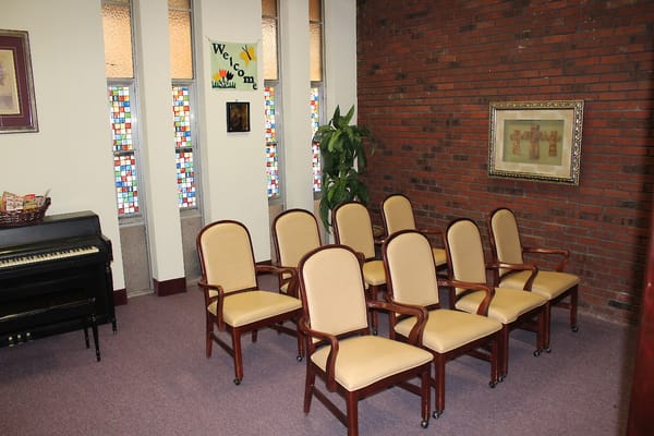Seating area in a warm indoor space with a welcome sign