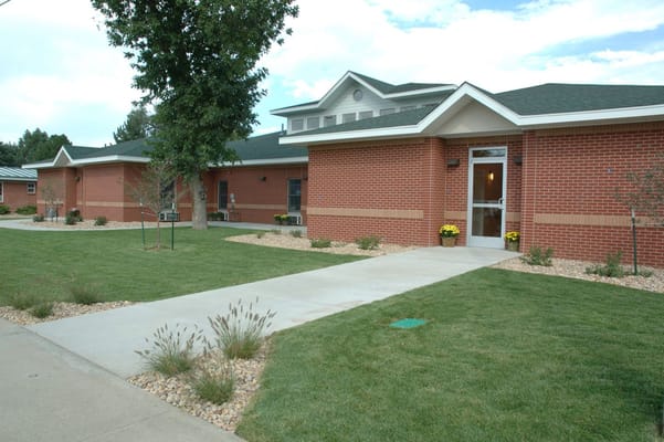 Exterior view of Peaks Care Center with landscaped pathways