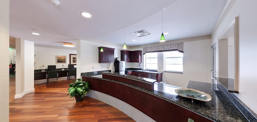 Interior view of a facility common area with kitchen