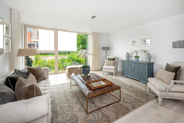 Bright and inviting common area with seating and garden view