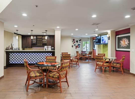 Café seating area with colorful chairs and tables
