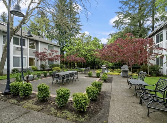 Outdoor courtyard with seating and landscaped gardens
