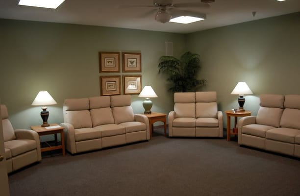 Cozy seating area with recliners and lamps