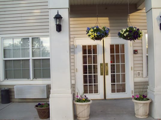 Entrance to a senior living facility with flowers