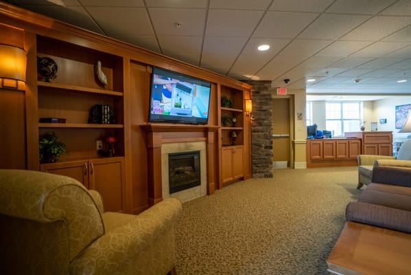 Warm and inviting lobby with seating and television