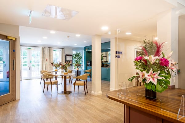 Bright common area with flowers and tables