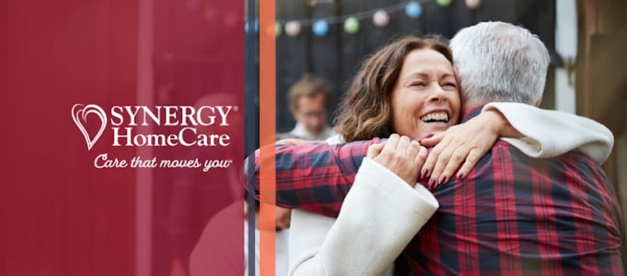 Logo of SYNERGY HomeCare with residents embracing